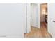 Hallway with wood-look flooring and white doors leading to a bedroom at 502 Edgefield Ridge Pl, Henderson, NV 89012