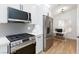 Well-lit kitchen with stainless steel appliances and ample counter space for cooking at 502 Edgefield Ridge Pl, Henderson, NV 89012