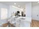 Open kitchen with white cabinets, a center island, stainless steel appliances, and bar stool seating at 502 Edgefield Ridge Pl, Henderson, NV 89012