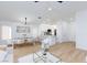 Elegant living room flows into a dining area with modern decor and hardwood floors at 502 Edgefield Ridge Pl, Henderson, NV 89012