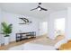 Bright bedroom includes ceiling fan, decorative display table, and en-suite bathroom access at 502 Edgefield Ridge Pl, Henderson, NV 89012