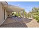 Inviting covered patio featuring a lattice roof, concrete flooring and views of the landscaped backyard at 502 Edgefield Ridge Pl, Henderson, NV 89012