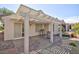 Comfortable covered patio with stone flooring and modern lattice roof for outdoor seating and relaxation at 502 Edgefield Ridge Pl, Henderson, NV 89012