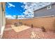 Spacious backyard with a table set on a sandy ground cover, ideal for outdoor activities at 505 Red Lovebird Ave # Lot 1229, Henderson, NV 89011