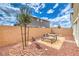Private backyard patio with rock landscaping, wooden bench, and a young tree at 505 Red Lovebird Ave # Lot 1229, Henderson, NV 89011
