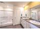 Well-lit bathroom featuring a double vanity, modern fixtures, and a glass-enclosed shower at 505 Red Lovebird Ave # Lot 1229, Henderson, NV 89011
