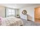 Bedroom showcasing a large window, neutral tones, and a dresser with decorative accents at 505 Red Lovebird Ave # Lot 1229, Henderson, NV 89011
