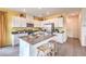 Bright kitchen with white cabinets, stainless steel appliances, and a center island with barstool seating at 505 Red Lovebird Ave # Lot 1229, Henderson, NV 89011