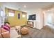 Cozy living room featuring a neutral sofa, storage console, and bright, sunny walls at 505 Red Lovebird Ave # Lot 1229, Henderson, NV 89011