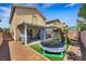 Backyard with a playset and trampoline and desert landscaping at 5321 Welch Valley Ave, Las Vegas, NV 89131