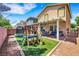 Backyard with a covered patio, playset, manicured lawn and a brick wall at 5321 Welch Valley Ave, Las Vegas, NV 89131
