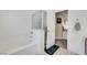White bathtub and shower with tile surround and a view into the en suite at 5321 Welch Valley Ave, Las Vegas, NV 89131