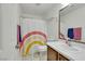 Clean bathroom featuring a rainbow curtain, new hardware, and a nice mirror at 5321 Welch Valley Ave, Las Vegas, NV 89131