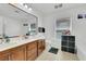 Bathroom with double sinks, a large mirror and ceramic tile flooring at 5321 Welch Valley Ave, Las Vegas, NV 89131