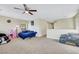 Open bedroom featuring carpet flooring, ceiling fan, and natural light at 5321 Welch Valley Ave, Las Vegas, NV 89131