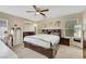 Spacious bedroom with a ceiling fan and a makeup vanity with storage at 5321 Welch Valley Ave, Las Vegas, NV 89131