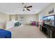 Spacious bonus room features plush carpeting, ceiling fan, and ample natural light, ideal for Gathering entertainment at 5321 Welch Valley Ave, Las Vegas, NV 89131