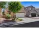 A well-maintained two-story home with a two-car garage, mature tree, and low-maintenance landscaping at 5321 Welch Valley Ave, Las Vegas, NV 89131