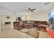 Open-concept living room with a sectional sofa, ceiling fan and tile flooring at 5321 Welch Valley Ave, Las Vegas, NV 89131