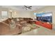 Spacious living room with a large, comfortable sectional sofa and a ceiling fan for added comfort at 5321 Welch Valley Ave, Las Vegas, NV 89131