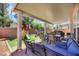 Covered backyard patio area featuring a seating area, outdoor kitchen and playset at 5321 Welch Valley Ave, Las Vegas, NV 89131