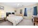 Bedroom features a bed with wood frame, carpeted floors, and natural light at 5456 Raccoon Valley Ln, Las Vegas, NV 89122