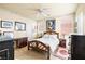 Bedroom with natural light, ceiling fan, wood flooring, light walls, and decorative trim at 5456 Raccoon Valley Ln, Las Vegas, NV 89122