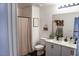 Well-lit bathroom features double sinks, modern vanity, and a shower with a stylish patterned curtain at 5733 Coral Sun St, North Las Vegas, NV 89031