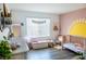 Charming Bedroom with a crib, soft accents, and a playful sun mural; ideal for a cozy space at 5733 Coral Sun St, North Las Vegas, NV 89031