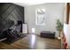 Versatile bonus room with wood-look flooring, a decorative accent wall, and ample natural light at 5733 Coral Sun St, North Las Vegas, NV 89031