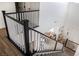 Bright entryway with staircase featuring dark wood and white railing, leading to an open living area with neutral decor at 5733 Coral Sun St, North Las Vegas, NV 89031