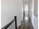 Hallway with wood floors leading to a laundry room with white appliances, bright and functional at 5733 Coral Sun St, North Las Vegas, NV 89031