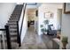Spacious hallway featuring tile and wood-look flooring, with a staircase and views into other rooms at 5733 Coral Sun St, North Las Vegas, NV 89031