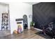 Bright home gym boasts stylish black accent wall, sleek mirror, and modern exercise equipment for a complete workout space at 5733 Coral Sun St, North Las Vegas, NV 89031
