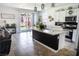 Open-concept kitchen featuring a large island, stainless steel appliances, and sliding glass doors to the backyard at 5733 Coral Sun St, North Las Vegas, NV 89031