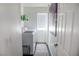 Well-lit laundry room featuring modern white appliances, practical shelving, and stylish decor at 5733 Coral Sun St, North Las Vegas, NV 89031