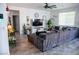Cozy living room features a large sectional sofa, tile floors, and a ceiling fan for added comfort at 5733 Coral Sun St, North Las Vegas, NV 89031