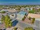 Single-story home boasts desert landscaping, circular driveway, and mountain views in a suburban neighborhood at 6490 Wagon Wheel Ct, Pahrump, NV 89061