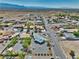 Expansive aerial shot of a desert community showcasing houses with spacious yards and mountain views at 6490 Wagon Wheel Ct, Pahrump, NV 89061
