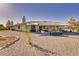 Expansive backyard featuring drought-tolerant landscaping, a covered patio, and plenty of space for outdoor activities at 6490 Wagon Wheel Ct, Pahrump, NV 89061