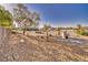 Landscaped backyard featuring mature trees, a gravel yard, drought-tolerant landscaping, and ample space for enjoyment at 6490 Wagon Wheel Ct, Pahrump, NV 89061