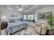 Bright bedroom with bay window, ceiling fan, and cozy armchair at 6490 Wagon Wheel Ct, Pahrump, NV 89061