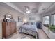 Bright bedroom with a ceiling fan, a dresser, and comfortable bedding at 6490 Wagon Wheel Ct, Pahrump, NV 89061