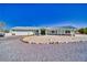 Single-story home boasts a gravel yard and rock accents for low maintenance desert living at 6490 Wagon Wheel Ct, Pahrump, NV 89061