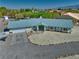 Aerial view of a home with mature landscaping, a spacious driveway, and a desert landscape at 6490 Wagon Wheel Ct, Pahrump, NV 89061