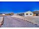Inviting home exterior featuring xeriscaping and a circular driveway leading to an attached two-car garage at 6490 Wagon Wheel Ct, Pahrump, NV 89061