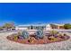 Desert landscaping and white gravel surround this single-story home with a matching detached garage at 6490 Wagon Wheel Ct, Pahrump, NV 89061