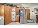 Kitchen with stainless steel refrigerator, oak cabinets, and a built-in oven and microwave at 6490 Wagon Wheel Ct, Pahrump, NV 89061