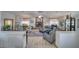 Spacious living room with wood-look floors, a stone fireplace, and plush seating with lots of natural light at 6490 Wagon Wheel Ct, Pahrump, NV 89061