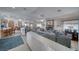 Open-concept living room with a stone fireplace, dining area, and a large sectional sofa at 6490 Wagon Wheel Ct, Pahrump, NV 89061
